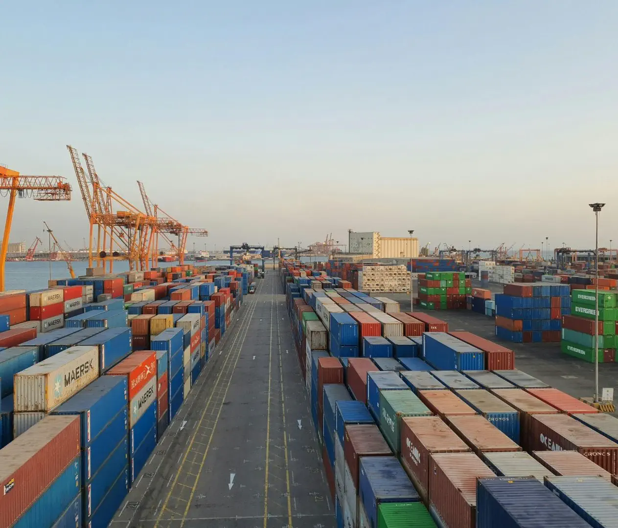 Port infrastructure with AI-driven inspection systems monitoring cranes, docks, and loading equipment for wear and potential failures